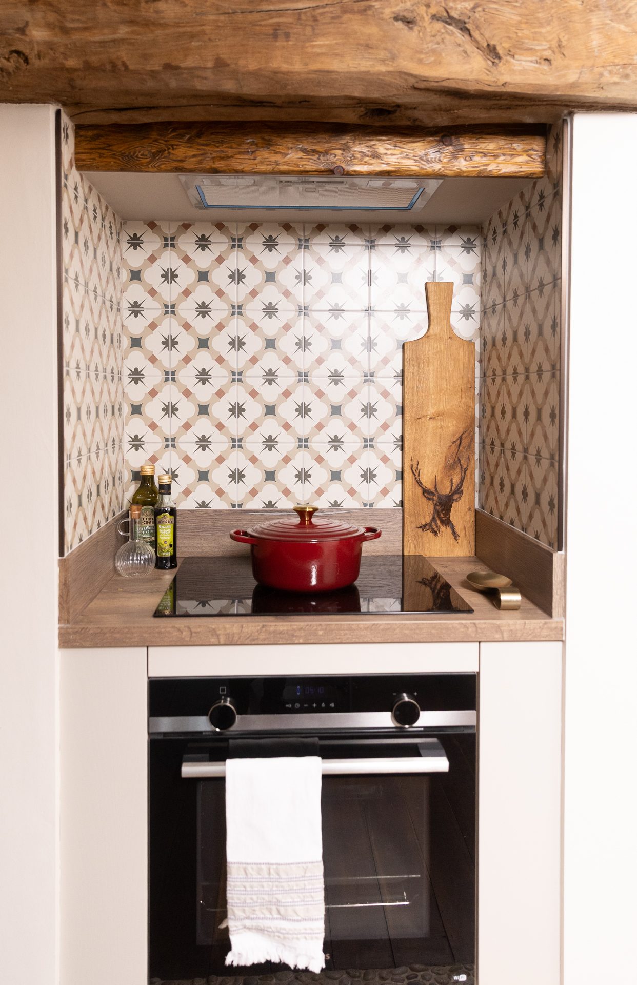 The cooking alcove at Bamburgh, a reclaimed sleeper beam above and a red pan below