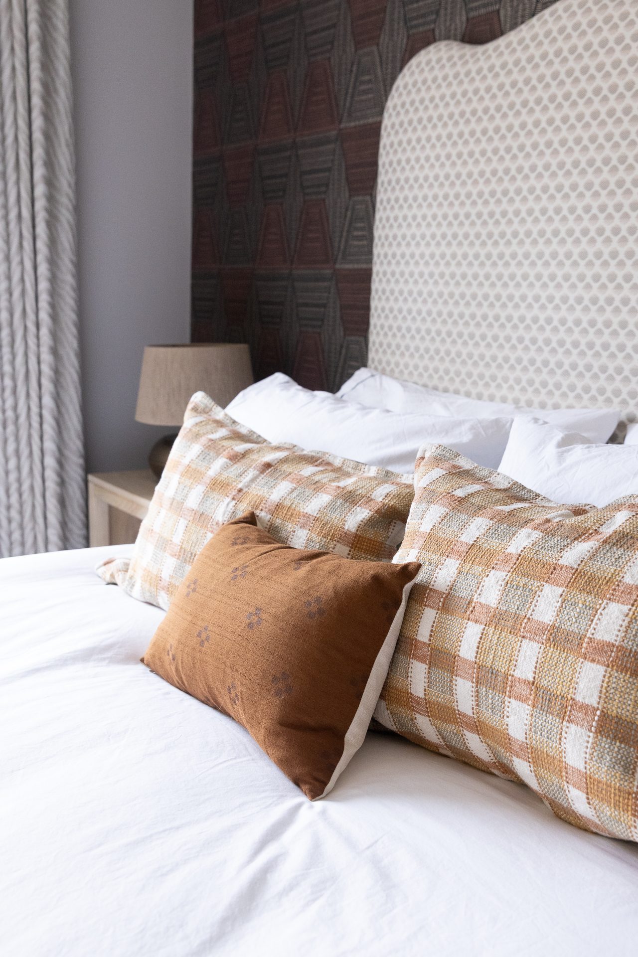 Layered plaid cushions at Elmfield Road