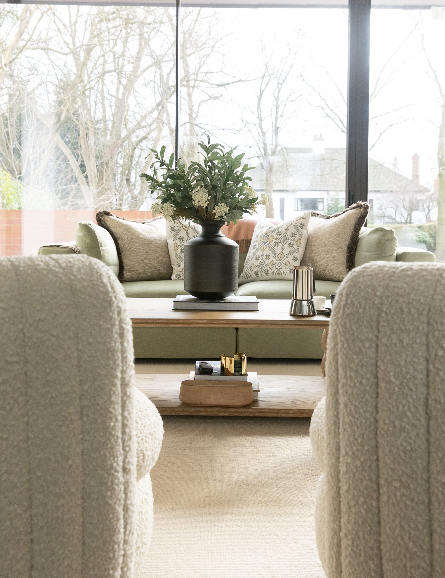 An intimate window seat moment in the living room, soft natural light