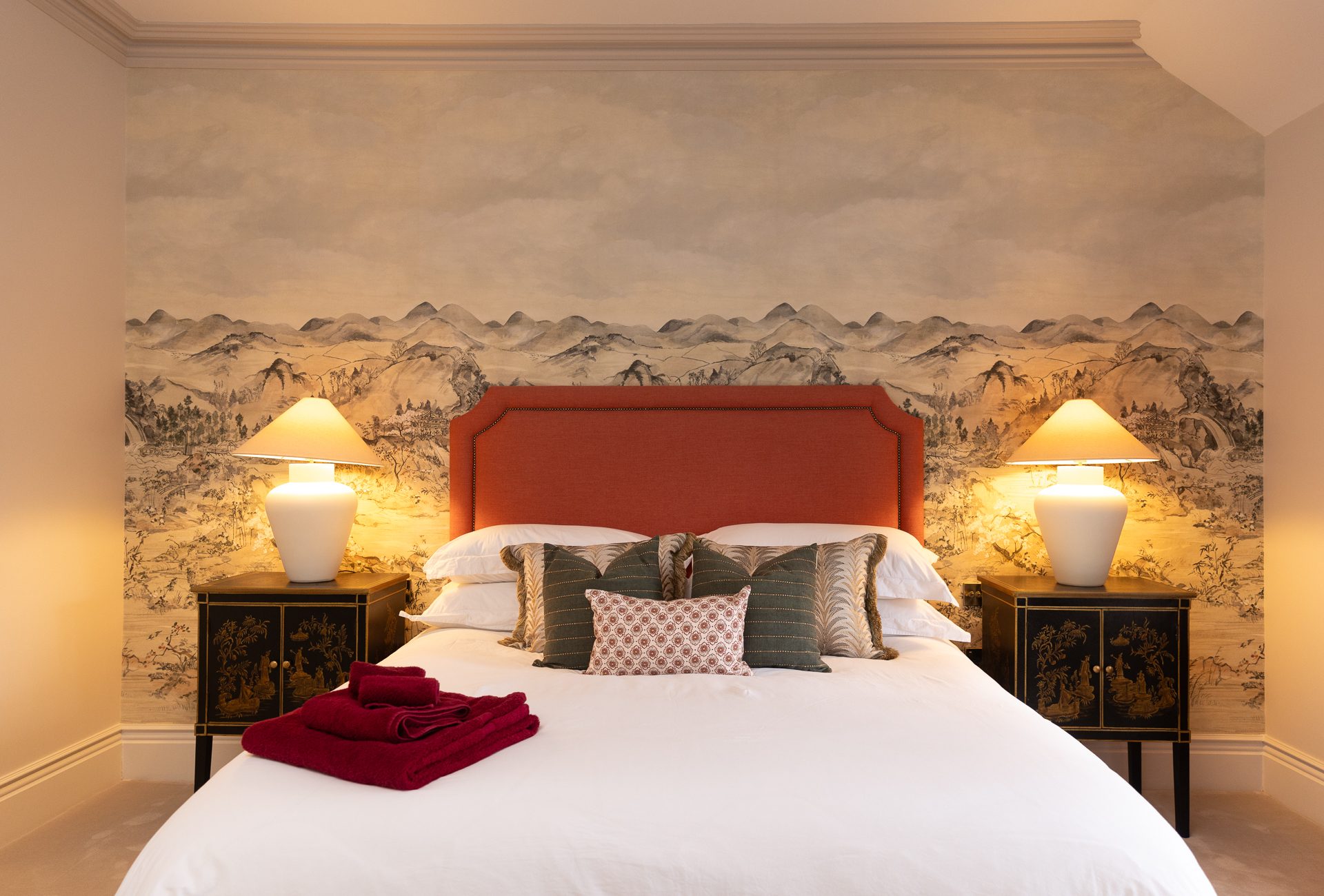 A second guest bedroom, softer palette with a low patterned headboard