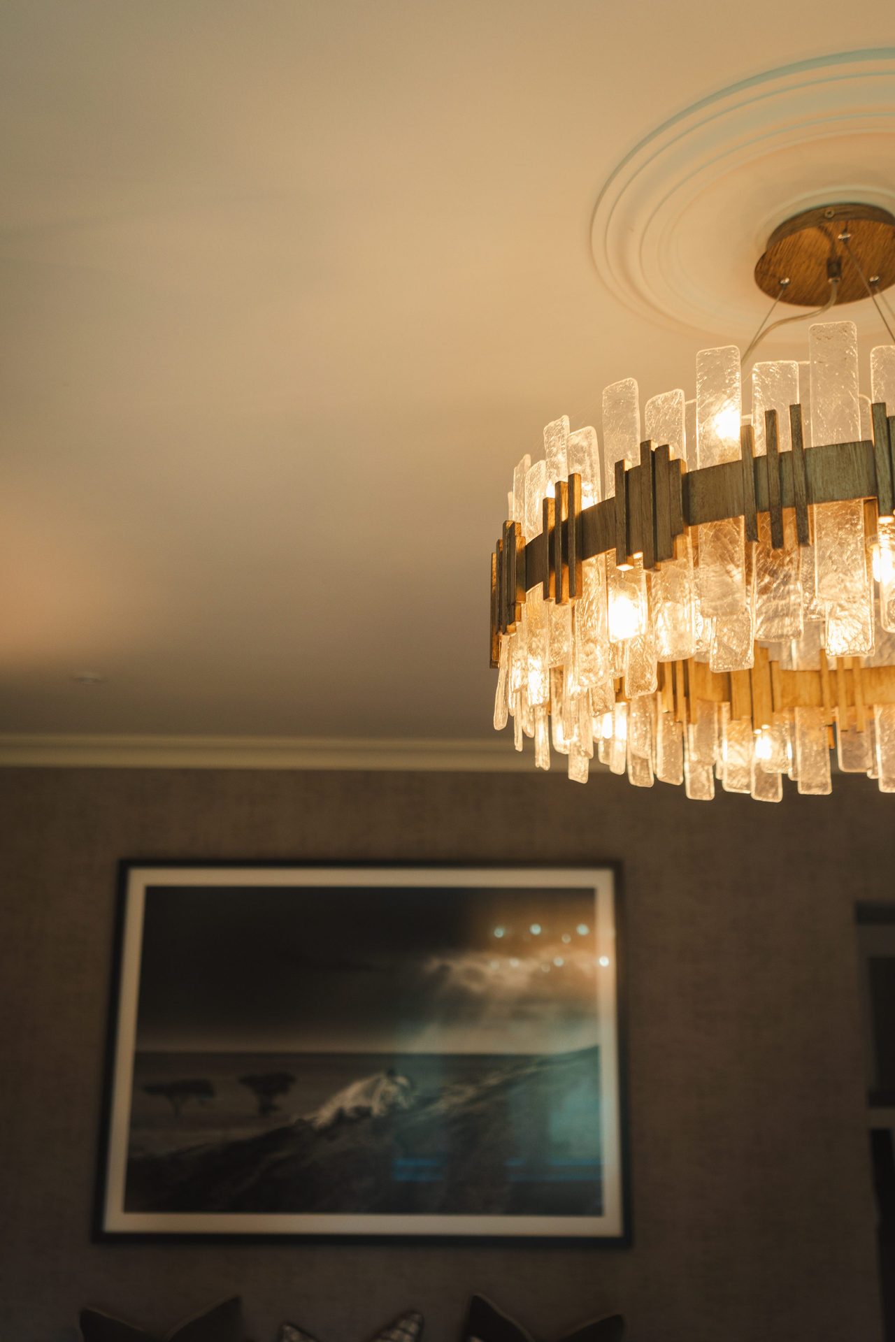 Crystal chandelier and ceiling rose detail in the bedroom, seen from below