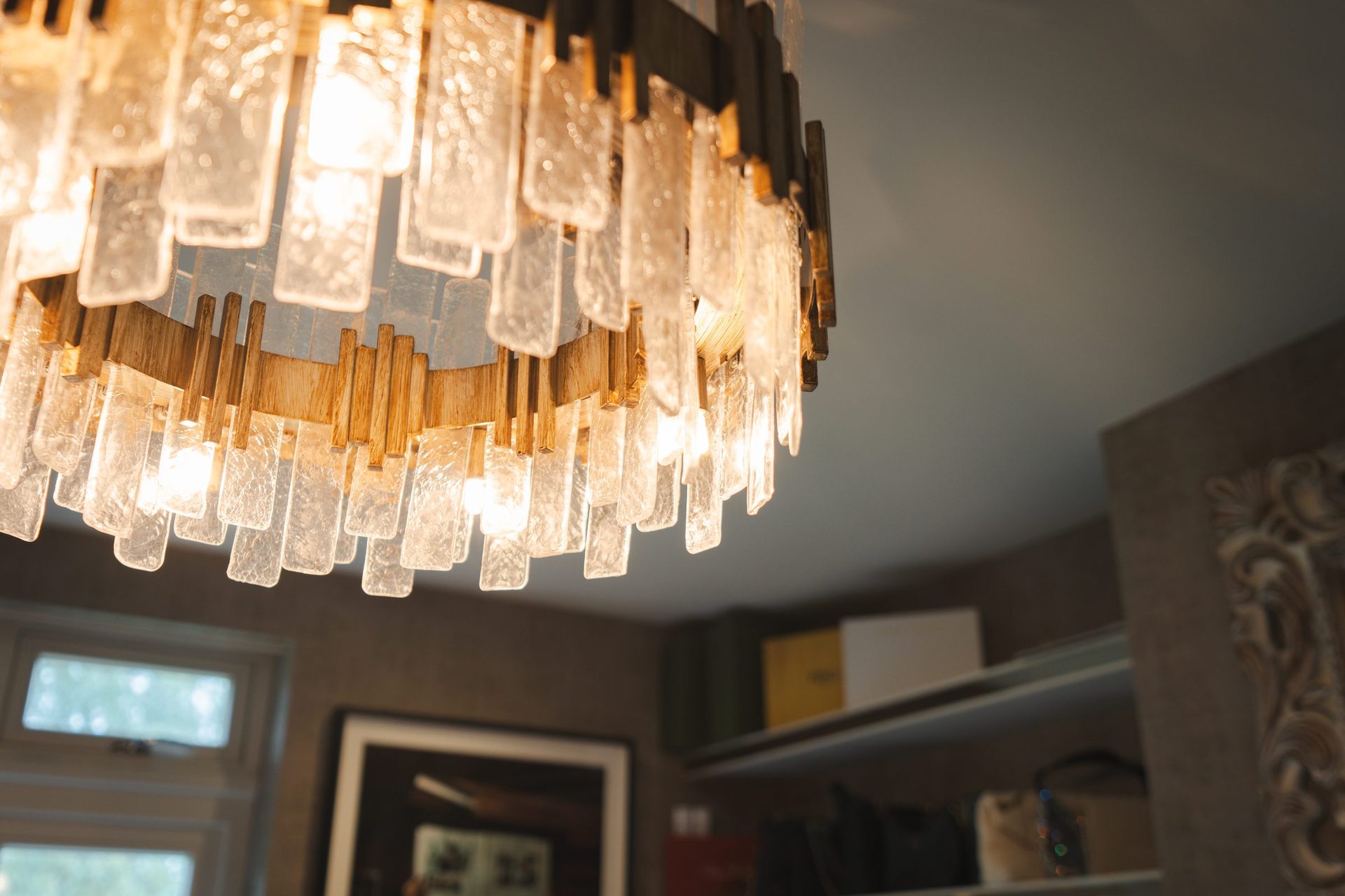 Detail of the crystal chandelier in the dressing room, cut glass rods catching the light against the dark walls