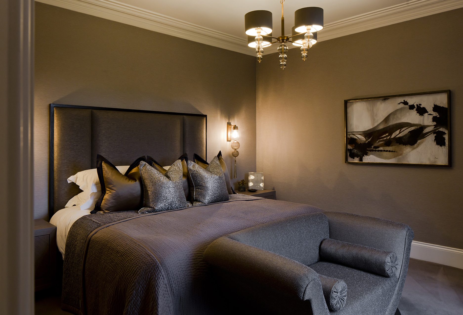 The bedroom suite, luxurious and moody, with layered textures and considered lighting